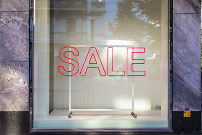 Scrabble letters spelling out the word "sale" against a mustard colour background.