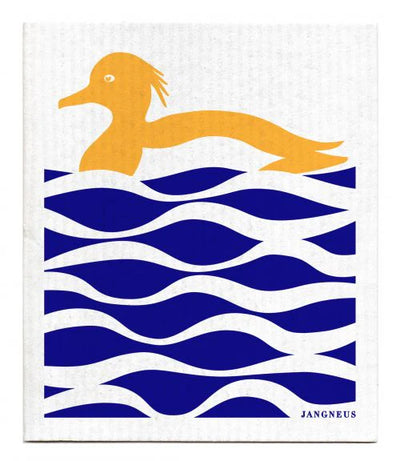 Orange mallard duck swimming on blue cobalt water. Water has noticeable solid wave patterns.